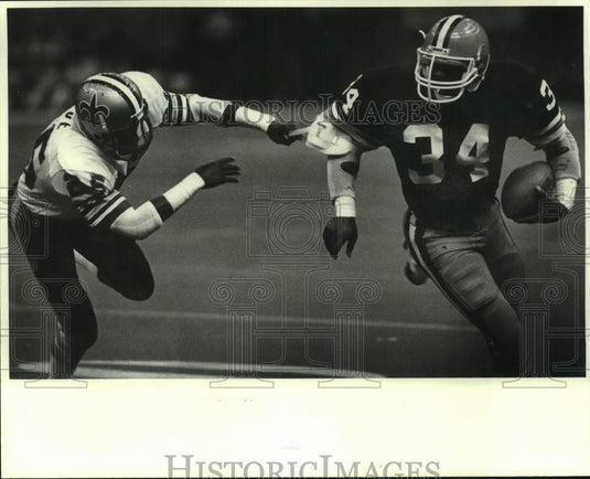 1982 Press Photo New Orleans Saints Johnnie Poe breaks grabs jersey of Green