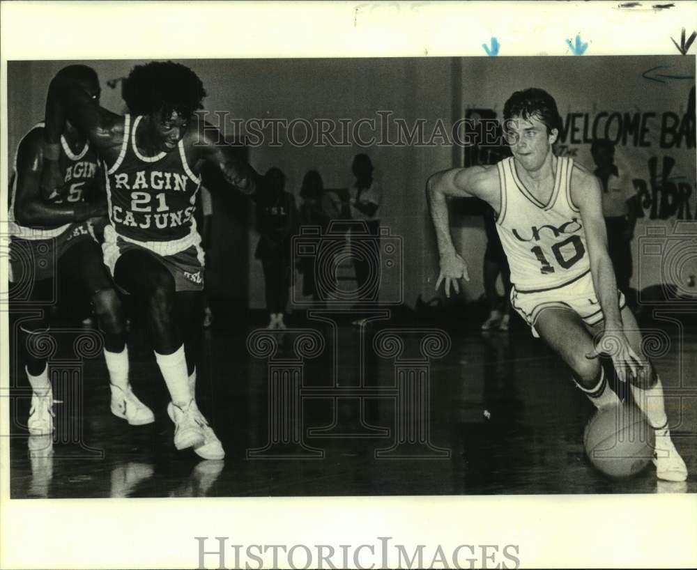 1981 Press Photo UNO basketball guard Tim Owens dribbles past opponents in game- Historic Images