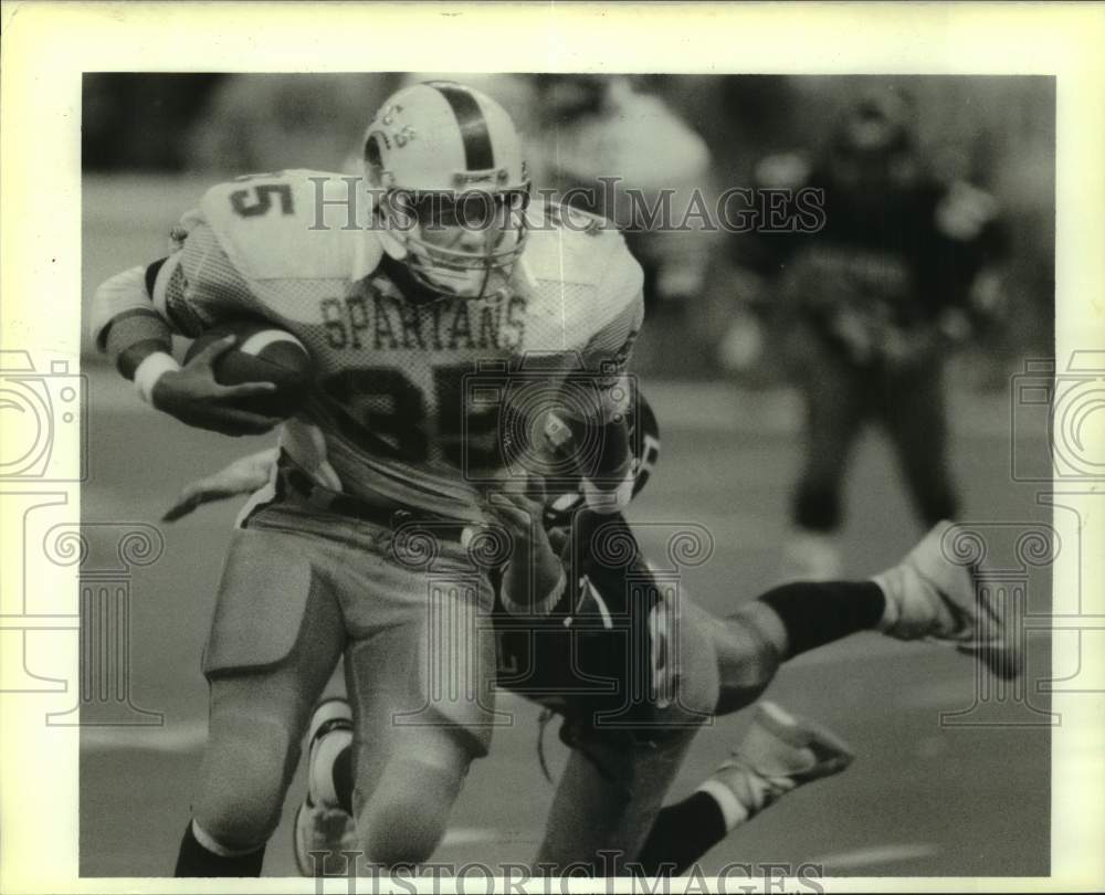 1988 Press Photo Ecole Spartan football player Jay Scardino brushes off defender - Historic Images