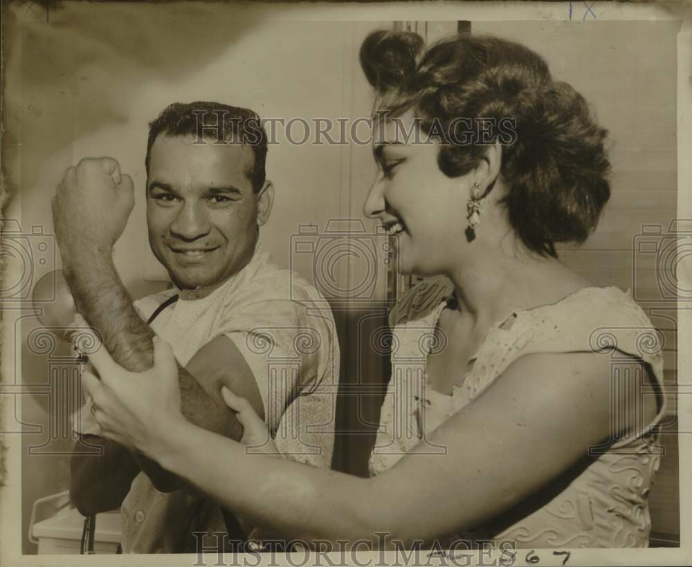 1957 Press Photo Boxer Ray Portilla flexes bicep for his wife Herminia - Historic Images