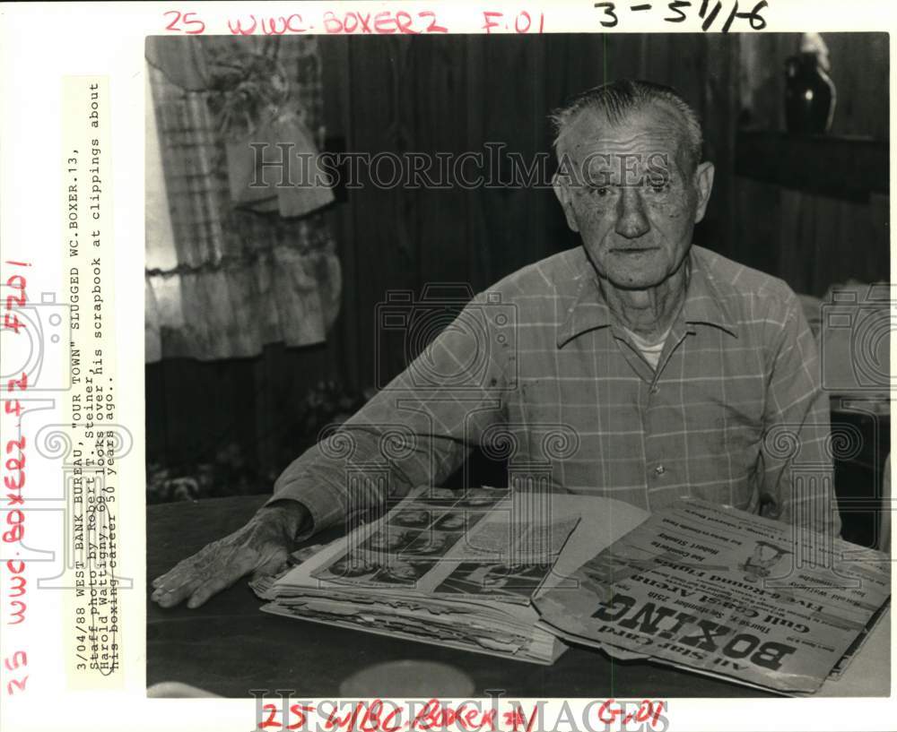 1988 Press Photo Former Boxer Harold Wattigny Looking Over Scrapbooks- Historic Images