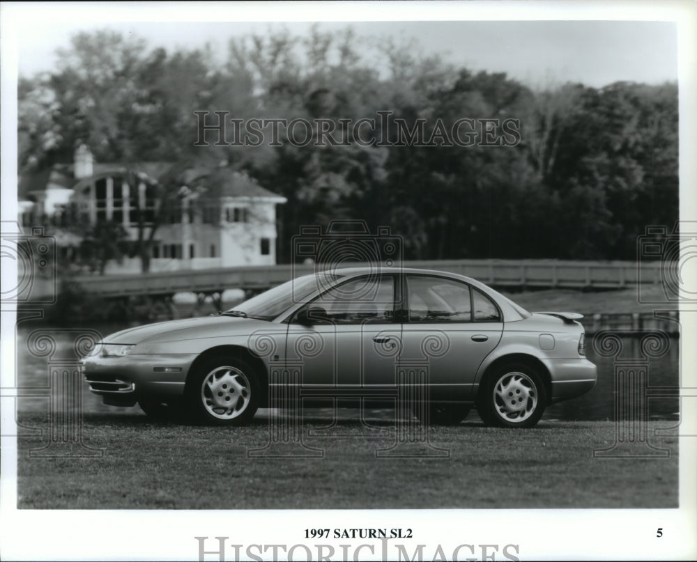 1997 Press Photo Saturn SL2 Four Door Vehicle Parked at Pond - not00567 - Historic Images