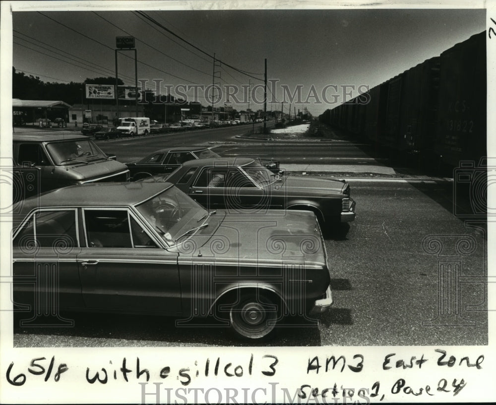 1980 Traffic stopped at railway crossing on Airline Highway - Historic Images