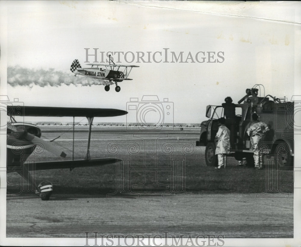 1973 Press Photo Fire Truck Stands Ready at Air Carnival as smoking plane lands-Historic Images