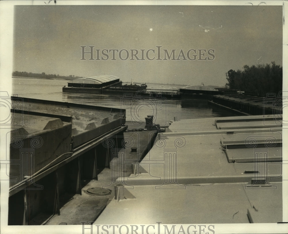 1973 Barges stand moored to steel cables on the levee at Harahan - Historic Images