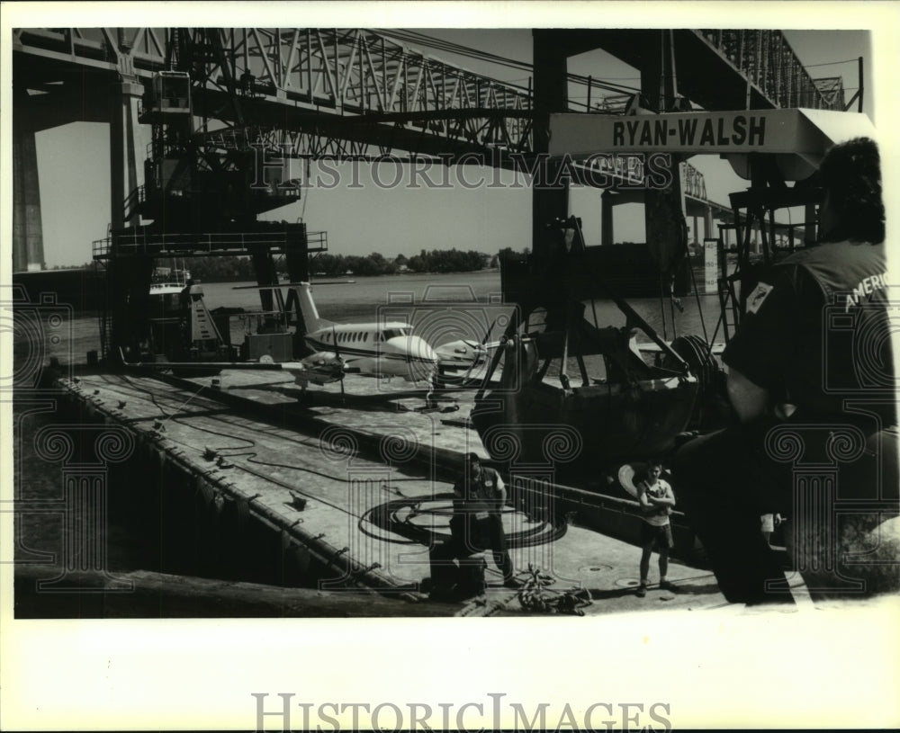 1994 Press Photo A Beachcraft twin-propeller plane is loaded onto a bardge - Historic Images