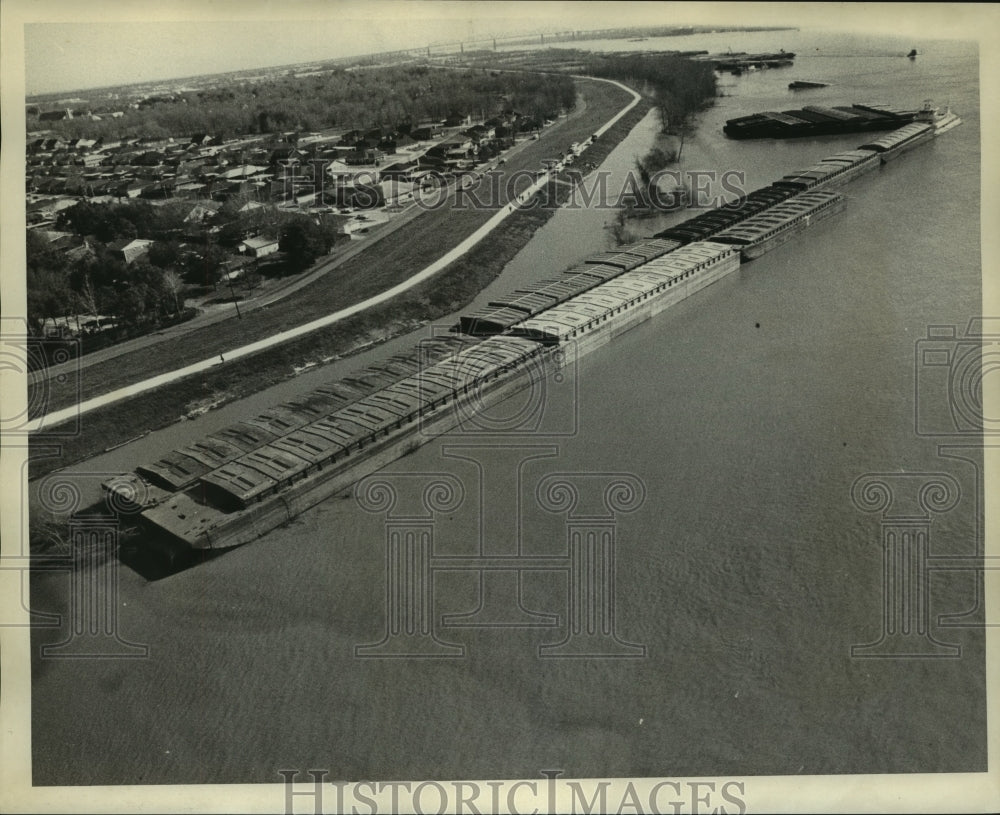 1974 Rows of barges neatly secured line the river - Historic Images