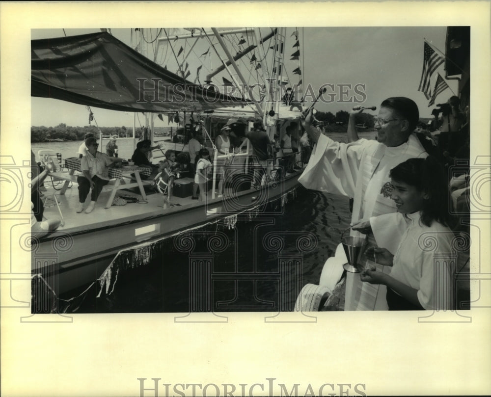 1990 Press Photo Father Donald Byrnes gives boat blessings at Delacroix Island - Historic Images