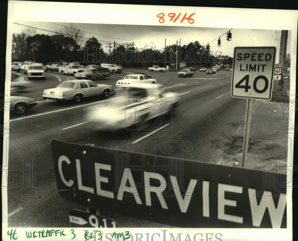 1987 Motorists&#39;s pass along the intersection of Clearview &amp; Airline - Historic Images