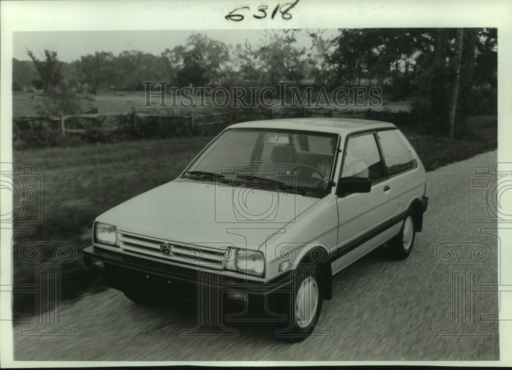 1988 Press Photo A new two-door Subaru Justy GL automobile out on the road - Historic Images