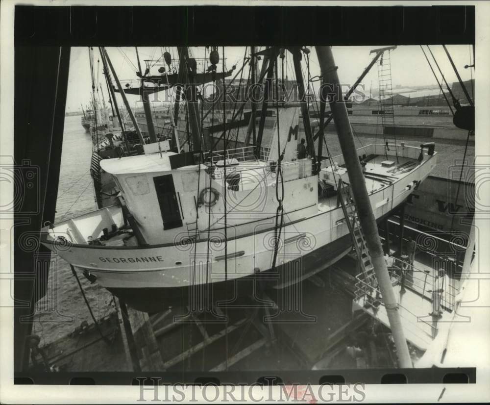 1969 Sail boat loaded to a freight ship for transportation-Historic Images