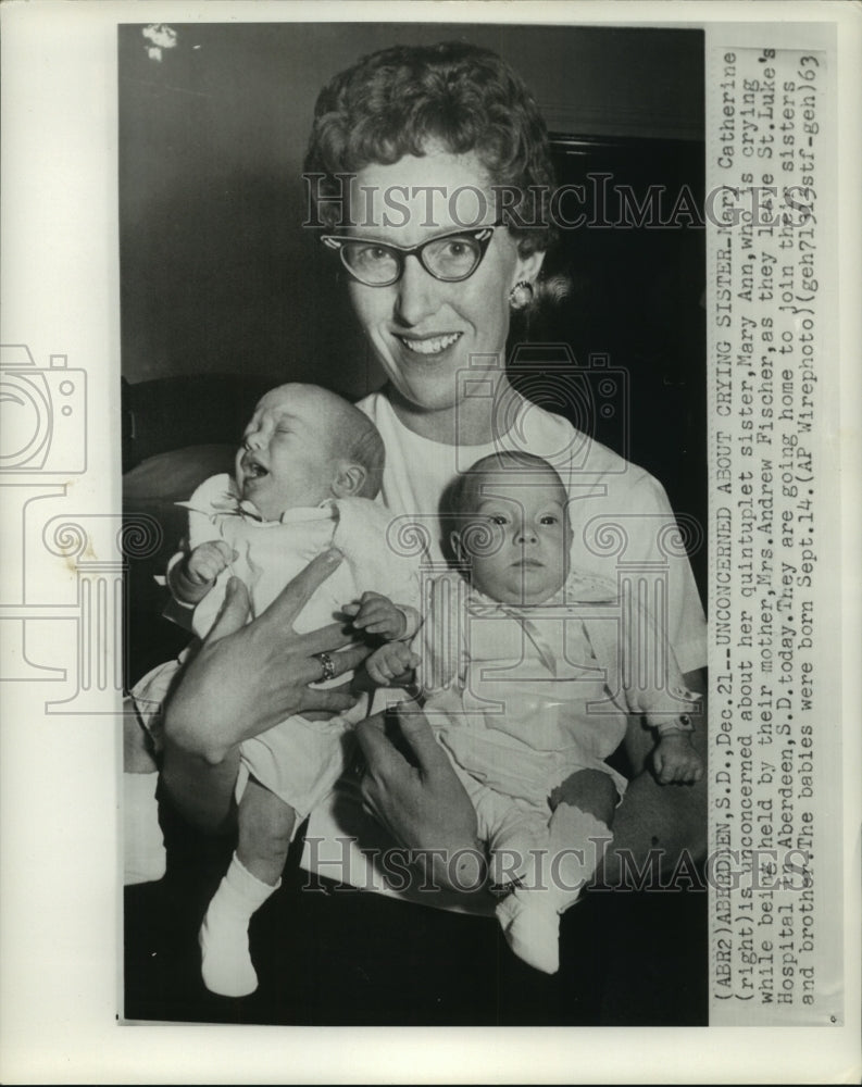 1963 Mrs. Andrew Fischer holds a crying and a contented baby - Historic Images