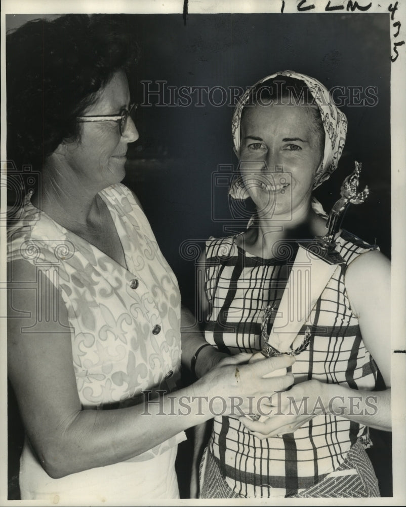 1962 Mrs. Harry Borden presents pirogue award to Gloria Freire. - Historic Images