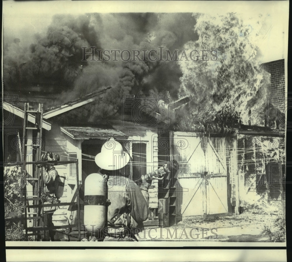 1971 Firemen respond to house fire, aftermath of earthquake. - Historic Images