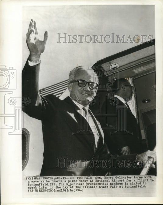 1964 Senator Barry Goldwater turns & waves as he boards plane - Historic Images