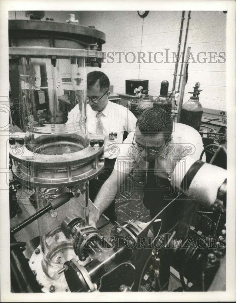 1961 Press Photo General Electric specialists check electric space engine - Historic Images