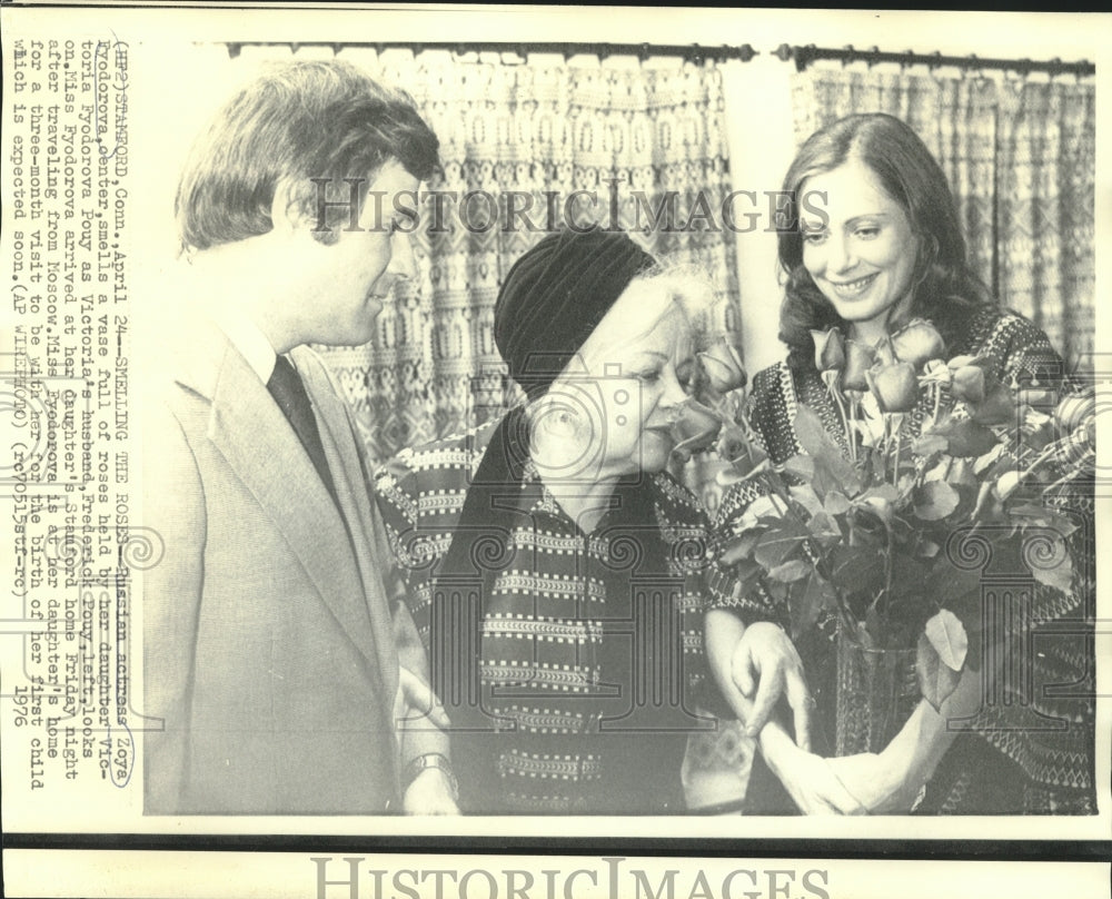 1976 Russian actress Zoya Fyodorova smells roses held by daughter - Historic Images