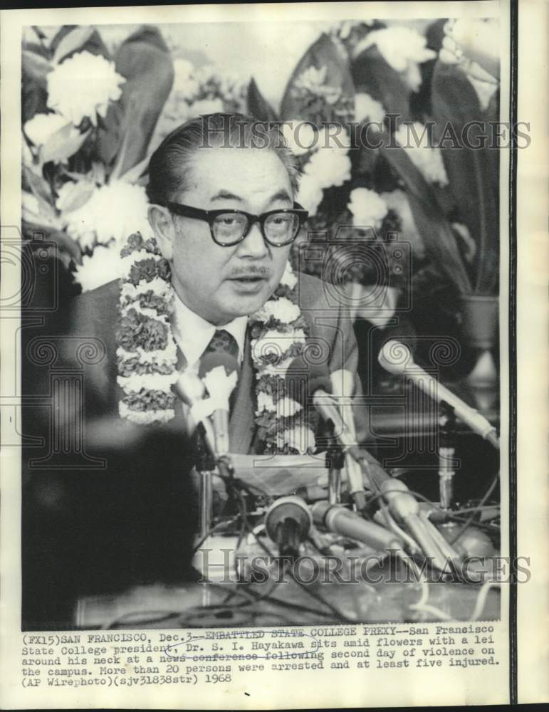 1968 Dr. S.I. Hayakawa with lei around his neck at news conference - Historic Images