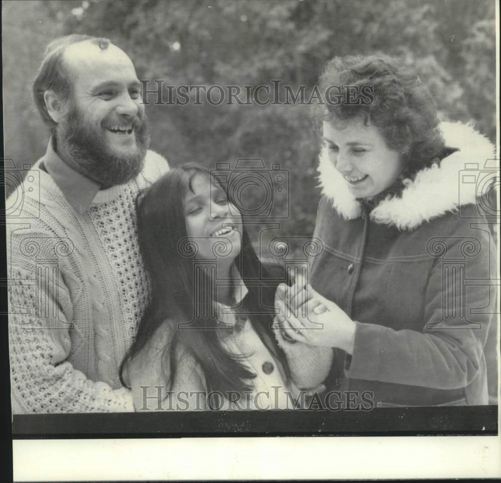 1974 Tepi, Bangladesh orphan meets new parents Peter &amp; Jean Hughes. - Historic Images