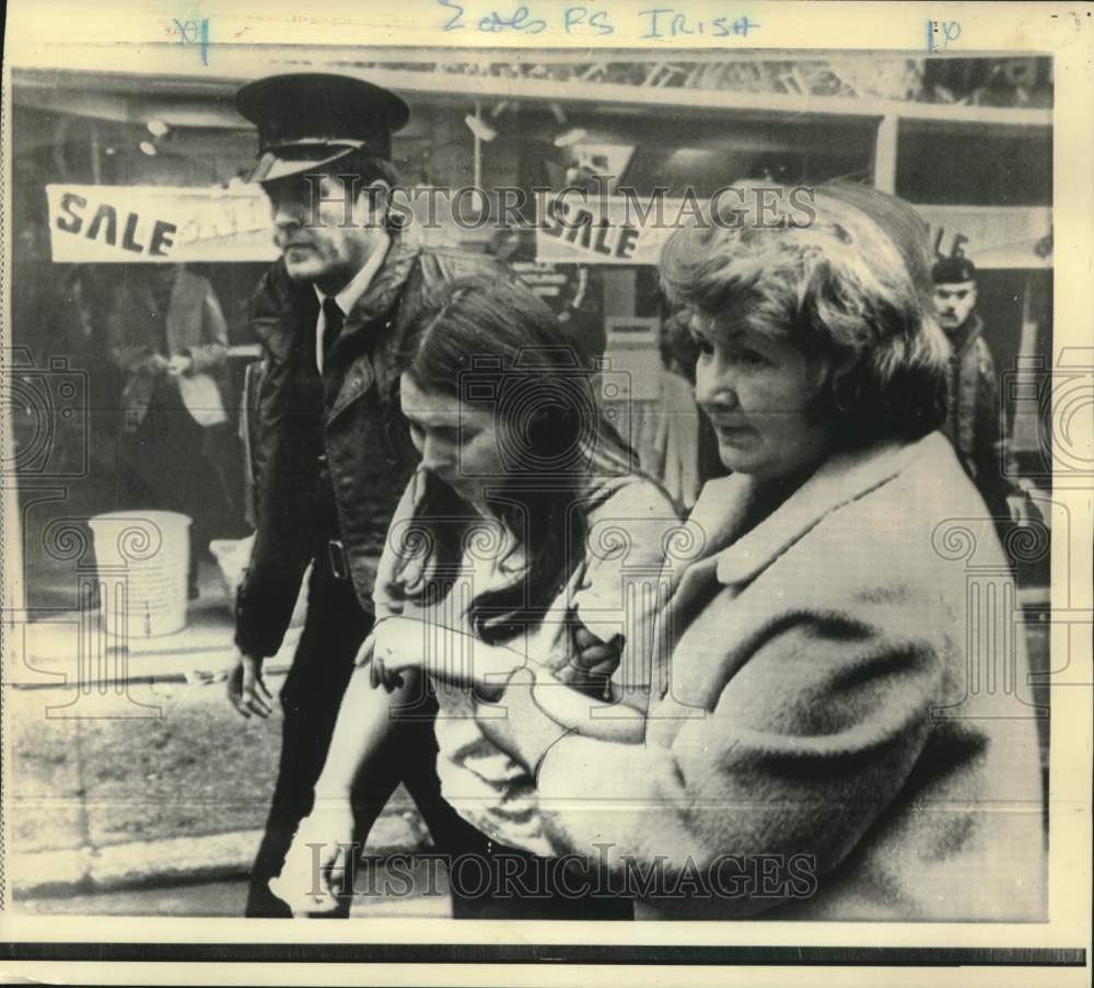 1972 Wounded girl escorted from bombed Belfast department store - Historic Images