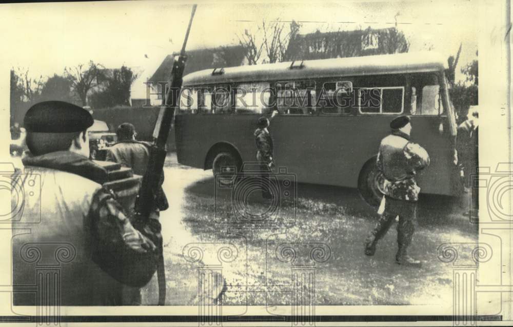 1973 Security forces guard detectives that check bombed bus - Historic Images