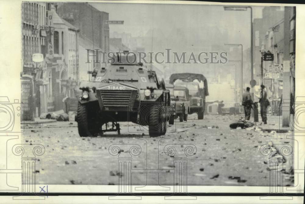 1969 Armored cars and trucks drive over rubble on Shankhill Road - Historic Images