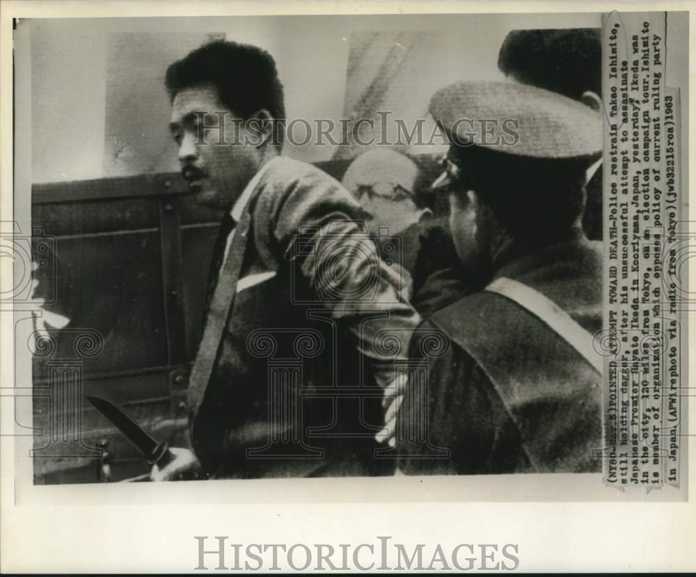 1963 Press Photo Police restrain Takao Ishimito after assassination attempt-Historic Images