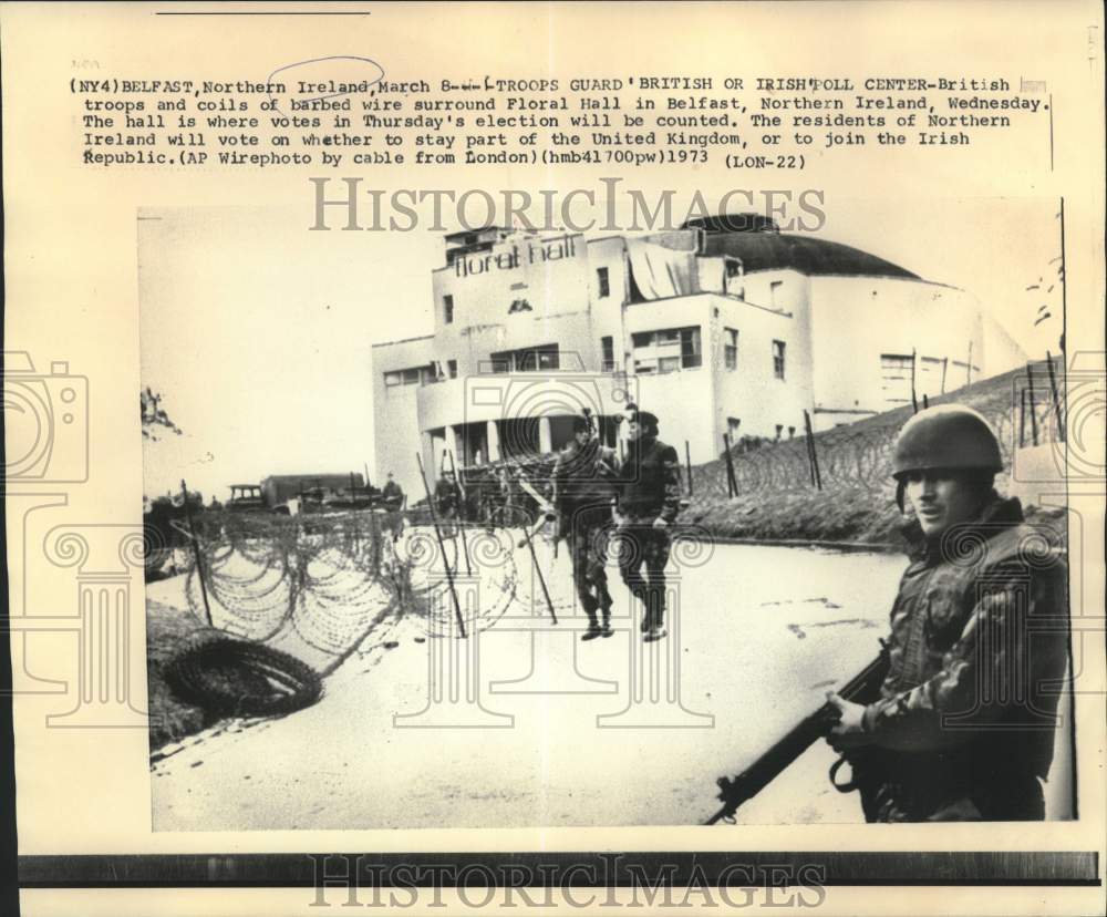 1973 British troops and barb wire suround Floral Hall in Belfast - Historic Images