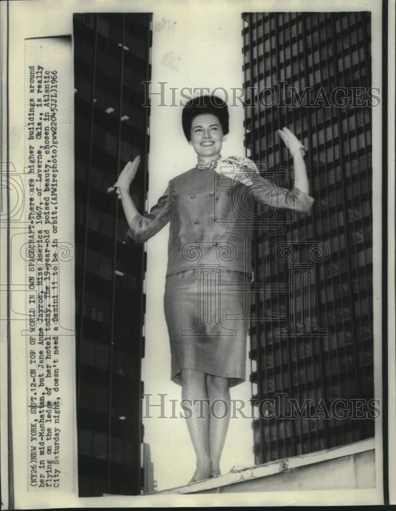 1966 Jane Anne Jayroe, Miss America 1967, on ledge of hotel - Historic Images