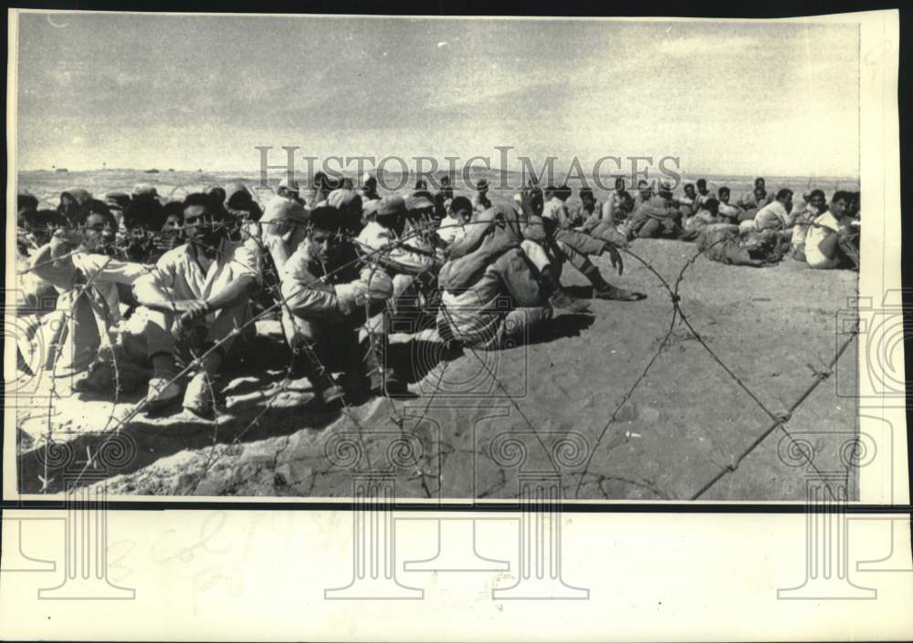 1973 Egyptian prisoners of war behind barbed wire near Suez Canal - Historic Images