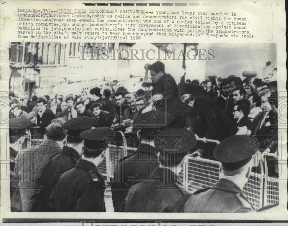 1968 Man leaps over Londonderry barrier in Northern Ireland - Historic Images