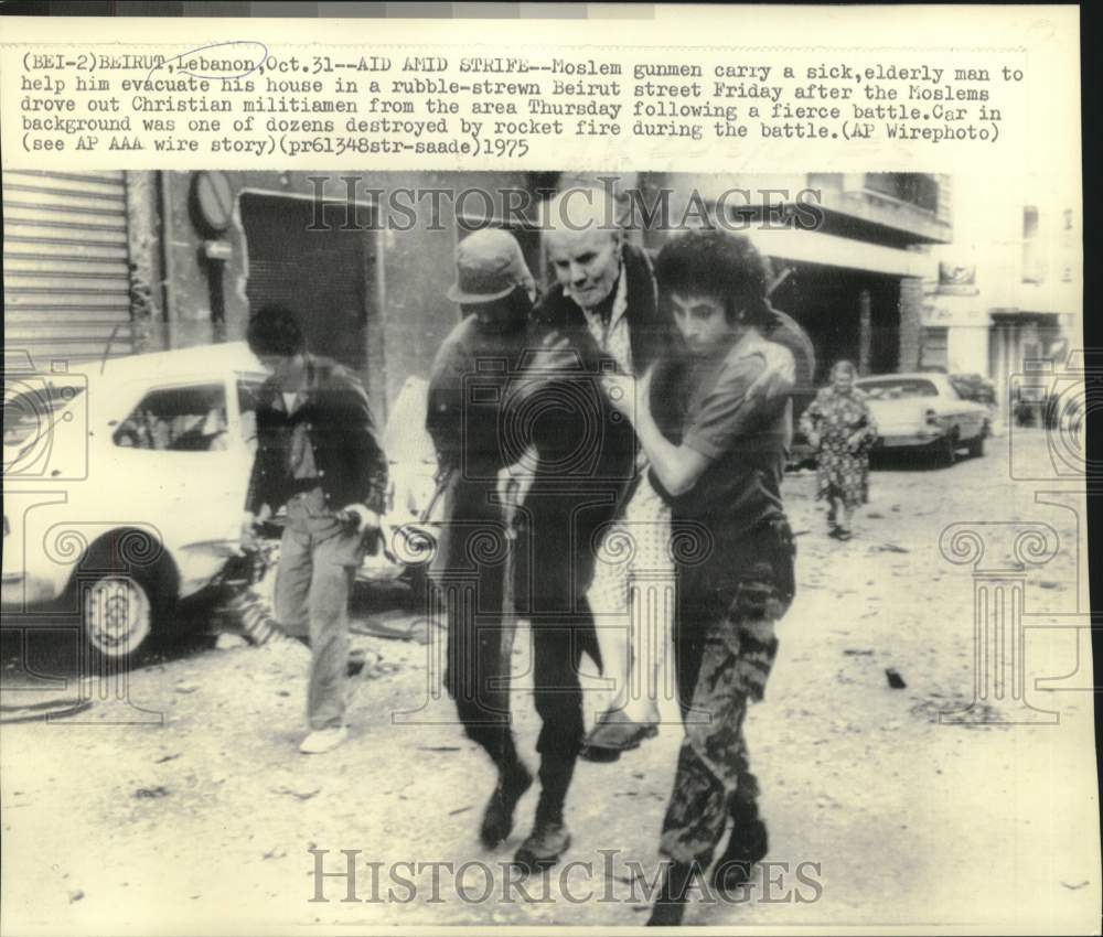 1975 Moslem gunmen carry sick, elderly man through streets of Beirut - Historic Images