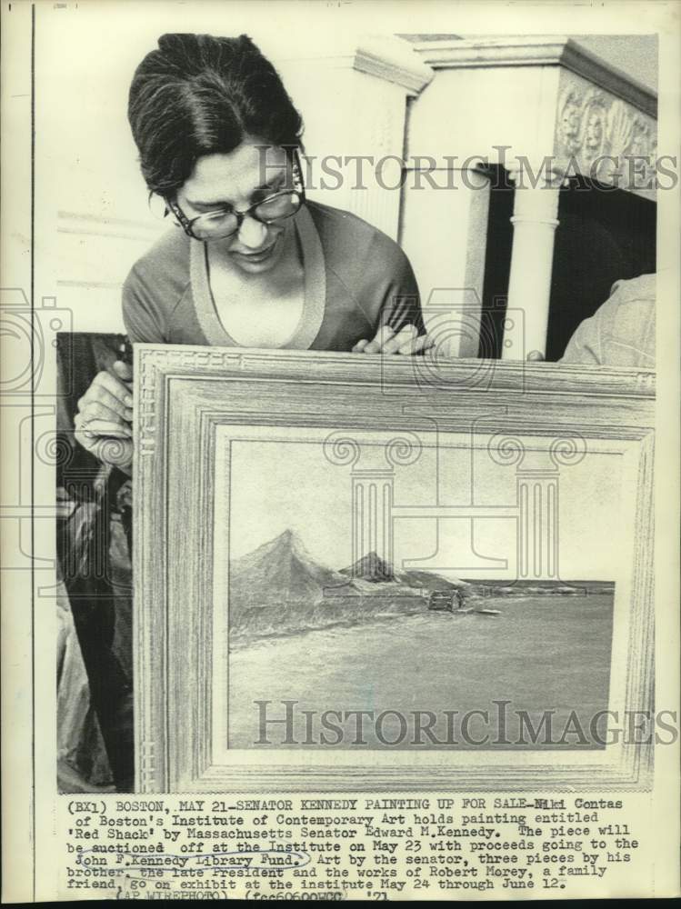 1971 Niki Contas holds painting "Red Shack" by Sen. Edward Kennedy - Historic Images