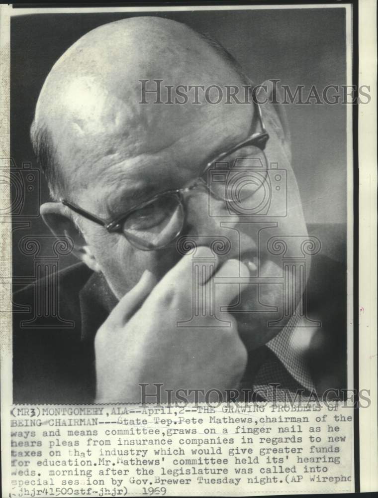 1969 Representative Pete Mathews gnaws on fingernail at hearing - Historic Images