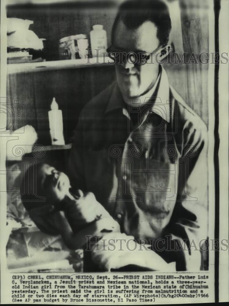 1966 Press Photo Father Luis hold three-year-old starving Mexican girl-Historic Images