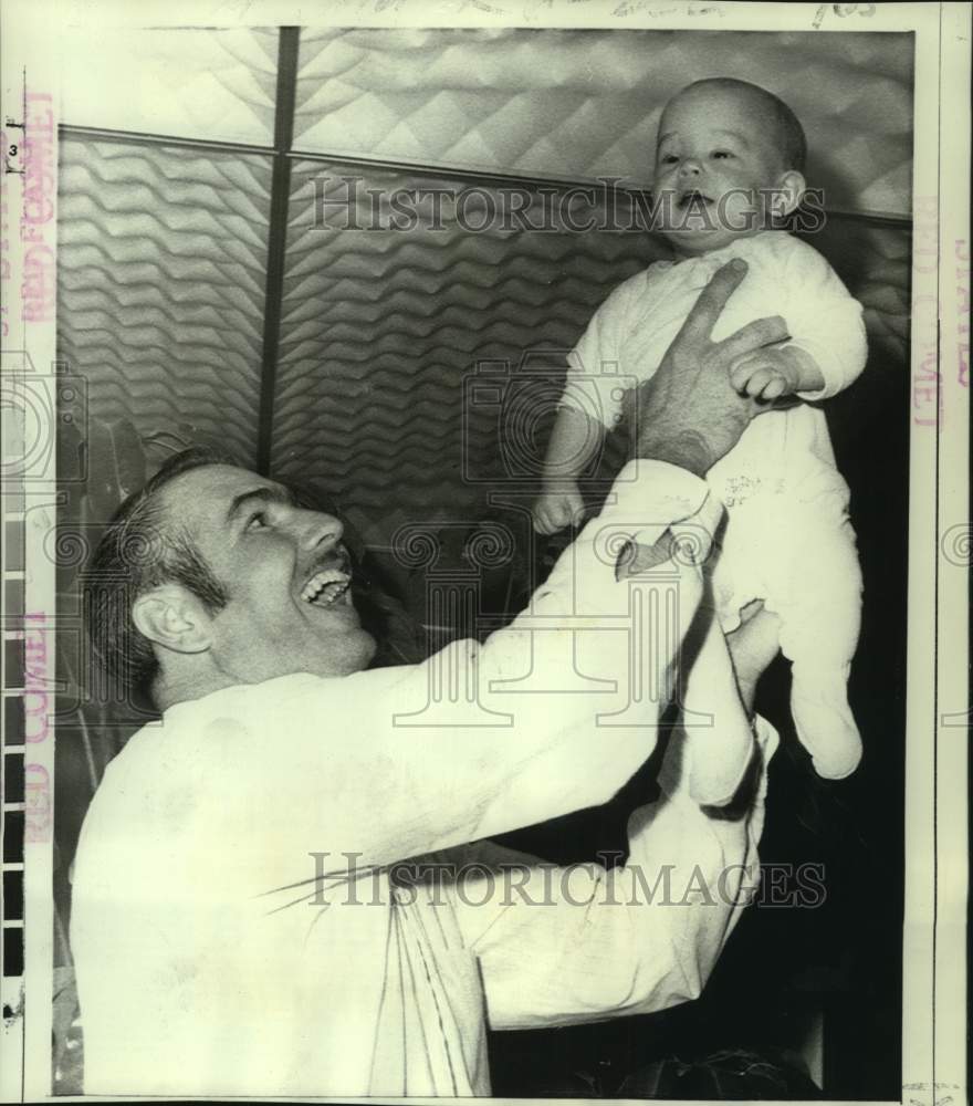 1970 J.L. Meiling holds son Neal at New York&#39;s Kennedy Airport - Historic Images