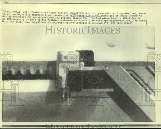 1973 Hijacker emerges from plane for passengers' breakfast - Historic Images