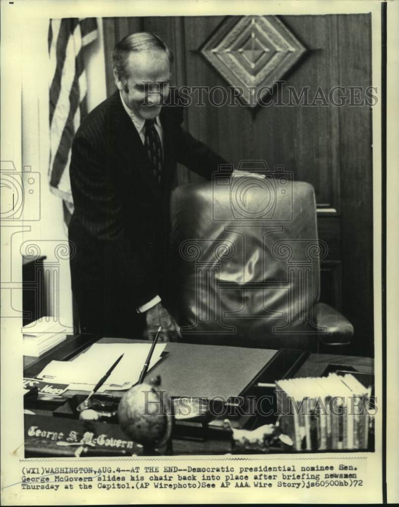 1972 Senator George McGovern slides chair into place at Capitol - Historic Images