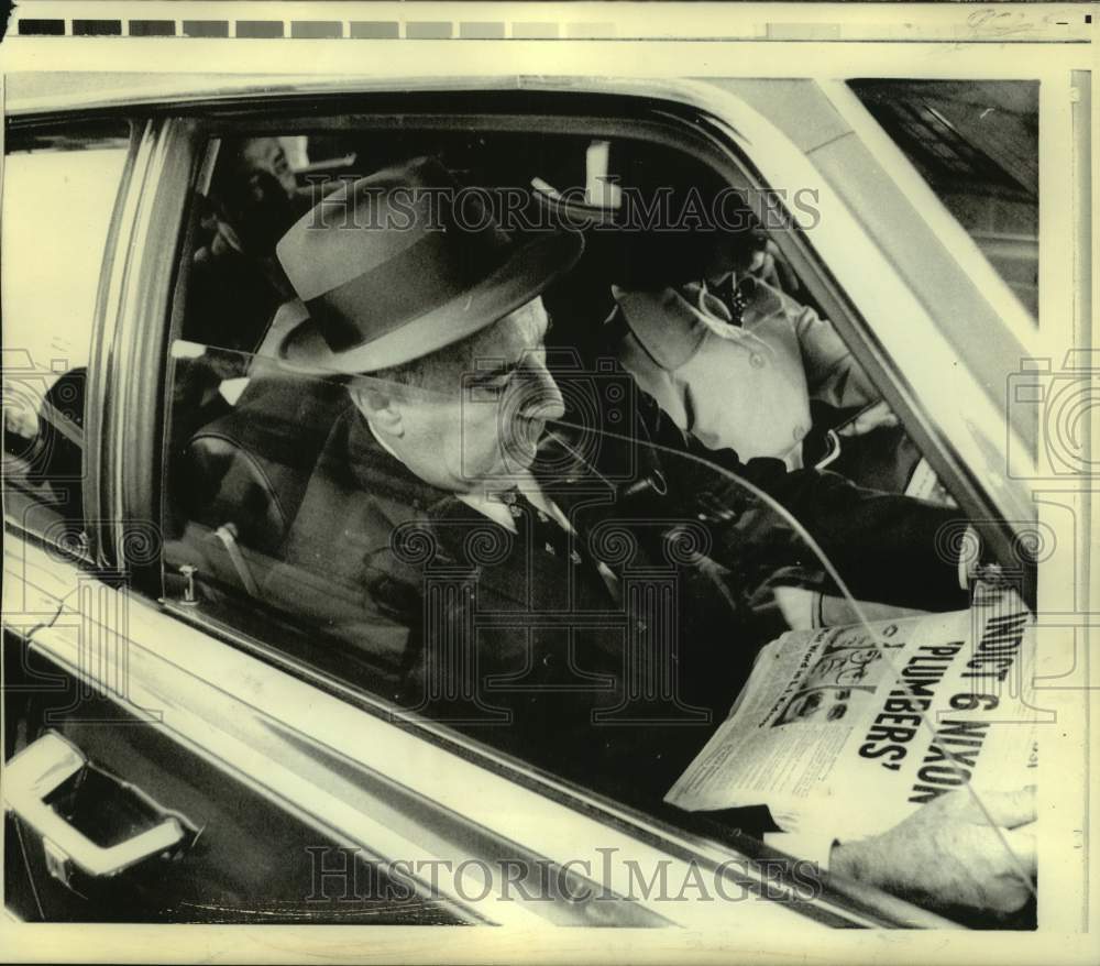 1974 Former Attorney General Mitchell reads New York newspaper - Historic Images