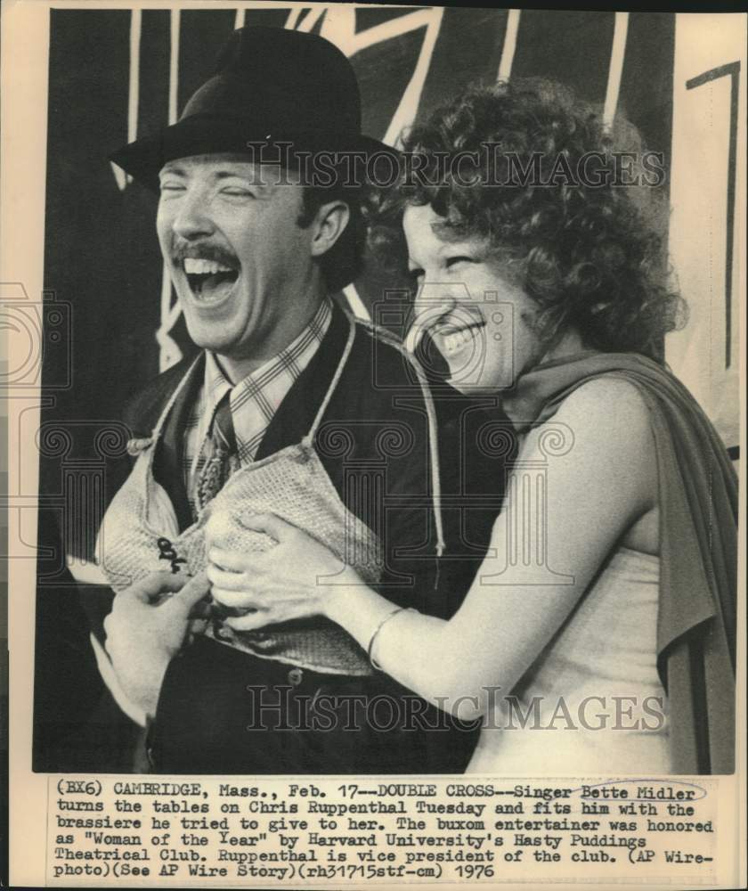 1976 Bette Midler fits brassiere on Ruppenthal at Hasty Puddings - Historic Images