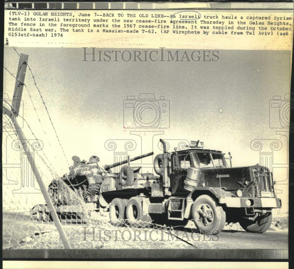 1974 Israeli truck hauls captured Syrian tank into Israeli territory - Historic Images