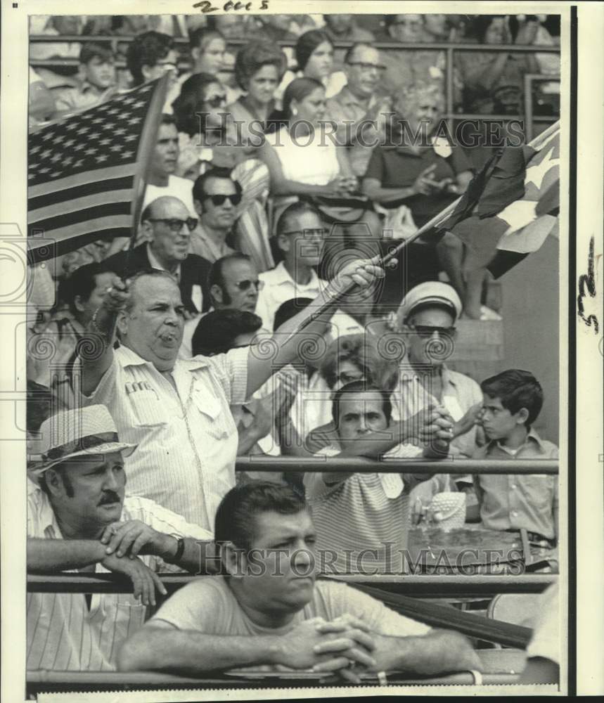 1971 Cubans wave flags at Miami, Florida freedom flight rally - Historic Images