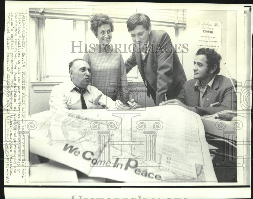 1969 End Vietnam War committee members look at map in Washington - Historic Images