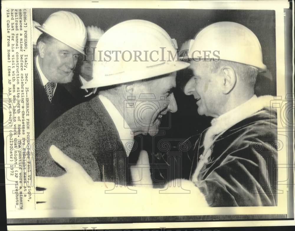 1972 Pope Paul VI, wearing hard hat, embraces Ponzano miner - Historic Images