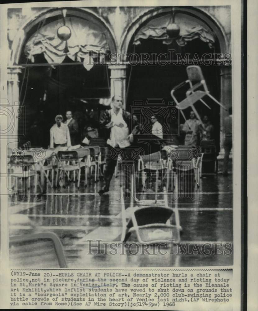 1968 Press Photo Demonstrator hurls a chair during rioting in St. Mark&#39;s Square - Historic Images