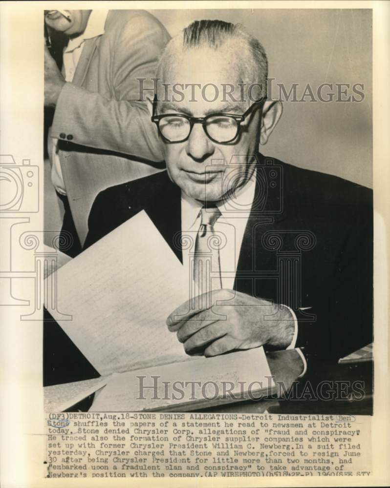 1960 Detroit industrialist Ben Stone shuffles papers at news brief - Historic Images