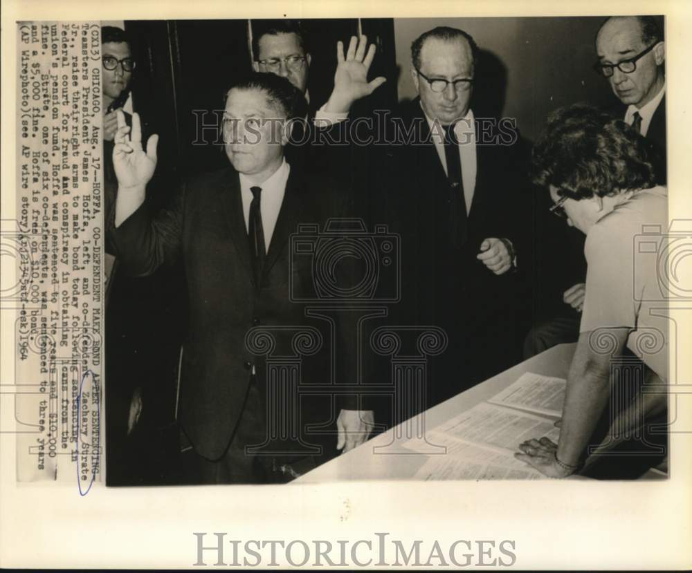 1964 Teamsters James Hoffa &amp; Zachery Strate raise arms to make bond - Historic Images