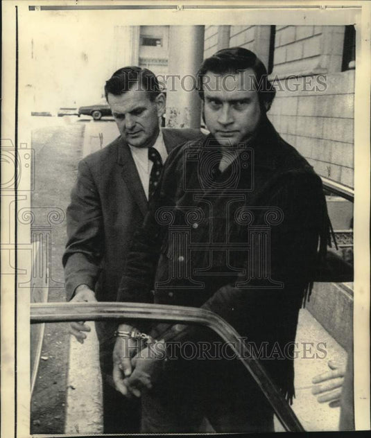1975 William Halm Williams, kidnapping suspect, in handcuffs - Historic Images