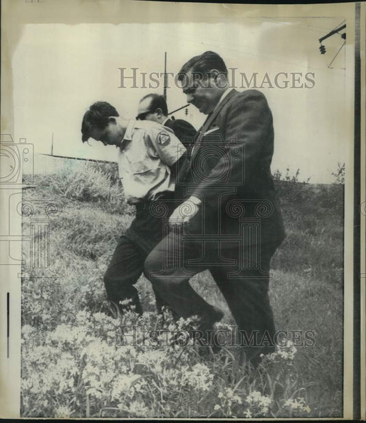 1968 John Whitmore escorted by policeman in Long Island, New York - Historic Images