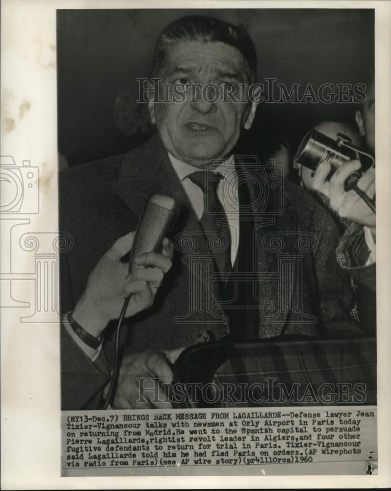 1960 Jean Tixier-Vignancour faces newsmen at Orly Airport in Paris - Historic Images